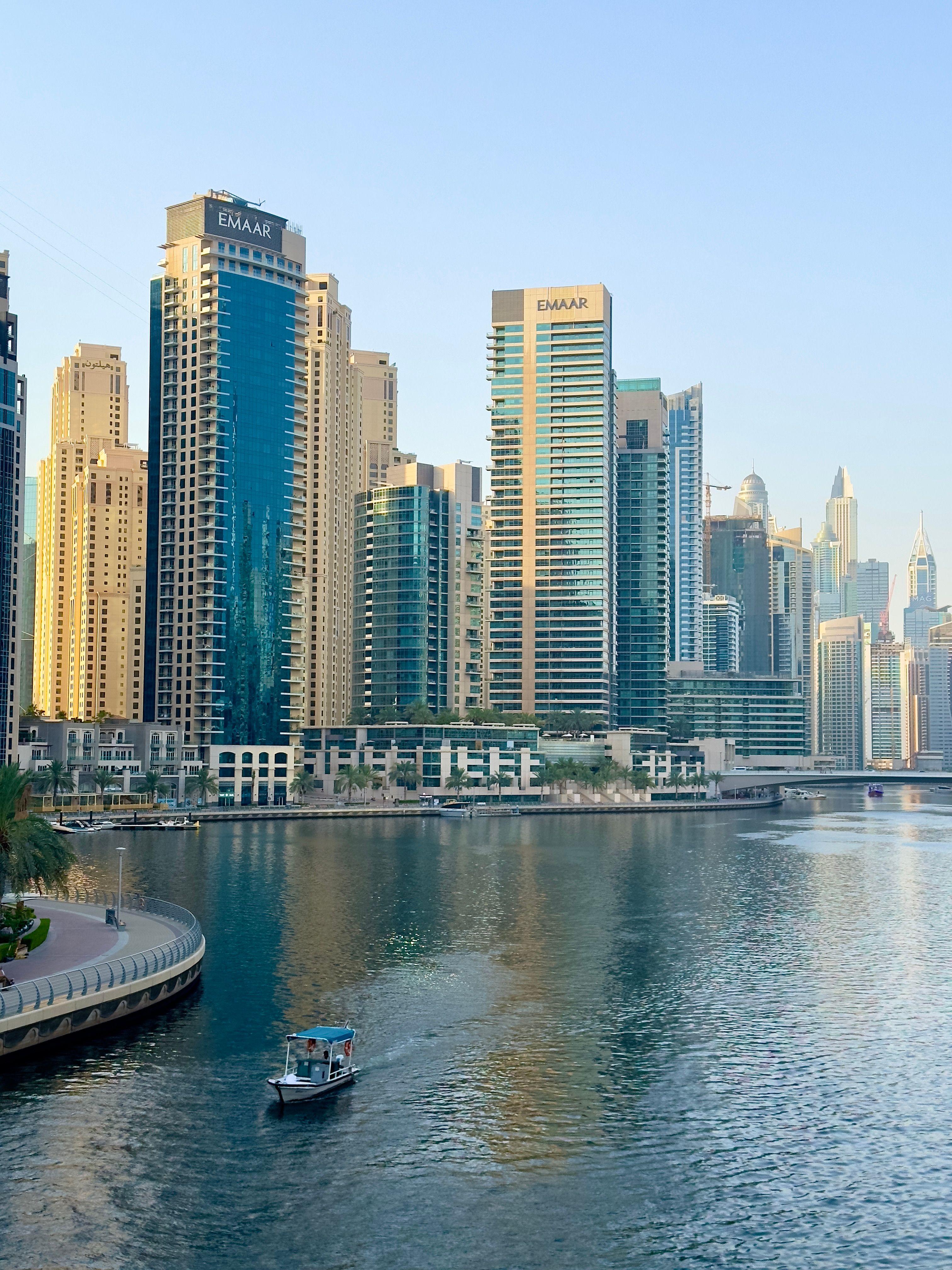 Dubai Marina skyline at dusk with illuminated high-rise towers along the waterway, representing the UAE base many remote workers and US LLC owners use for this visa.