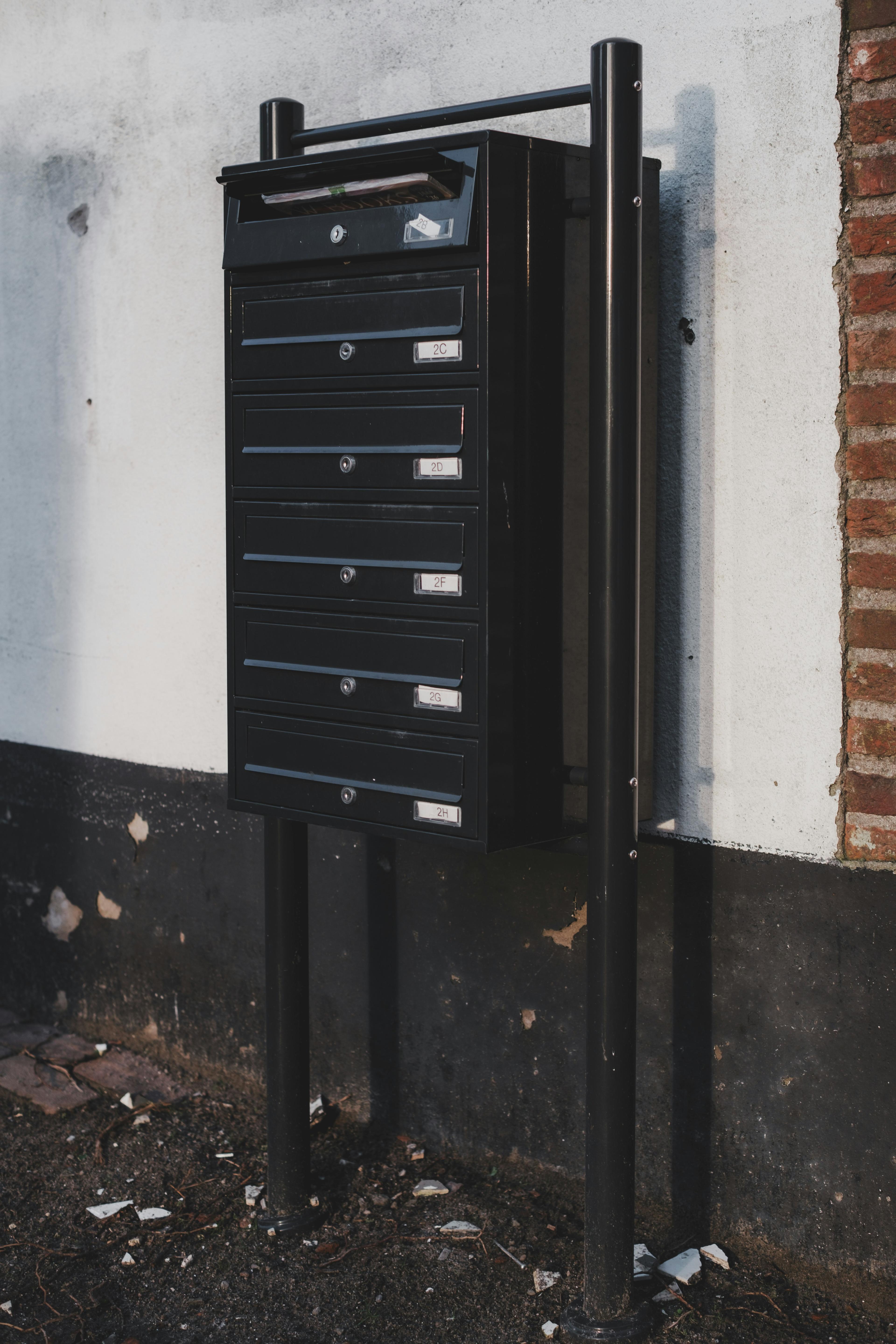 A row of labeled mailboxes, representing the official state mail a non-resident LLC owner relies on a registered agent to receive.